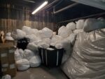 Large white bags filling a storage room.